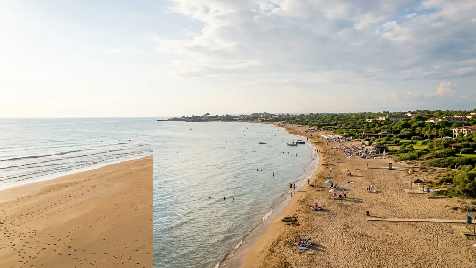 Kumkoy, Türkiye — the wide sandy beach at Kumkoy west of Side, calm shallow sea and a flat green coastal strip behind the shore.
