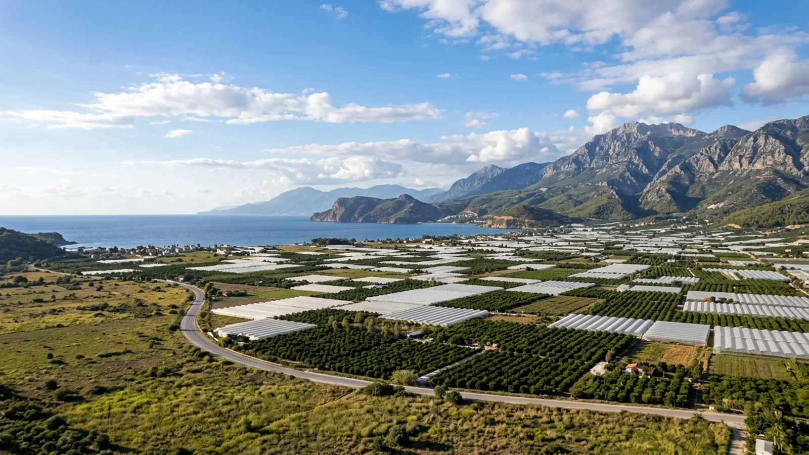 Kumluca, Türkiye — the plain at Kumluca on the western Antalya coast, a landscape of greenhouses and citrus groves between the mountains and the sea.