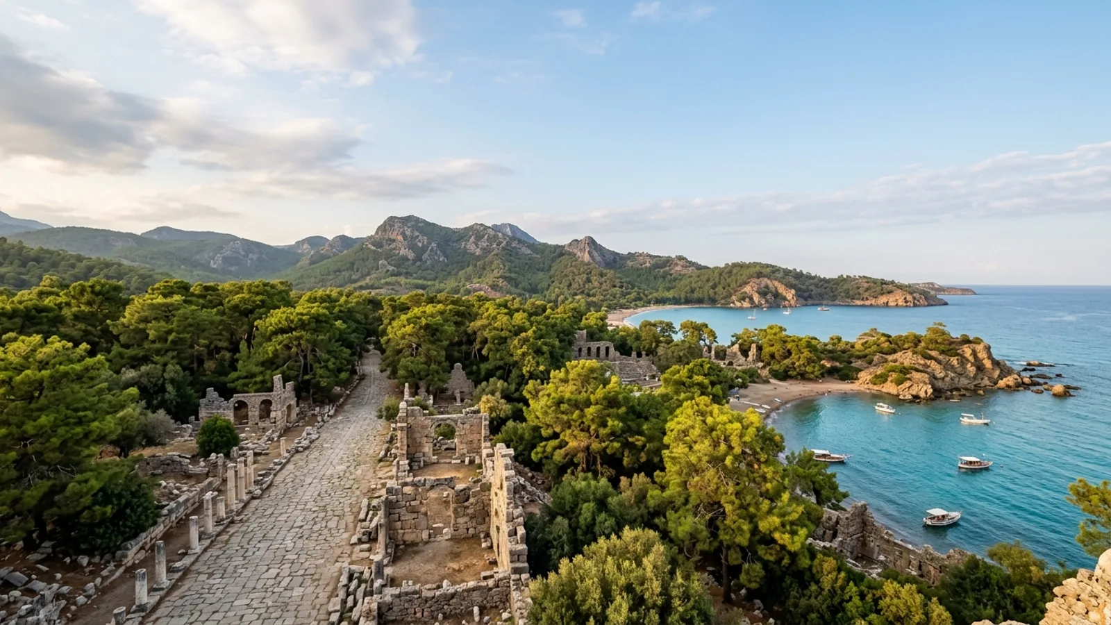 Phaselis, Türkiye — the ancient harbour city of Phaselis on the Antalya coast, weathered stone ruins and a paved ancient street among umbrella pines beside three small turquoise bays.